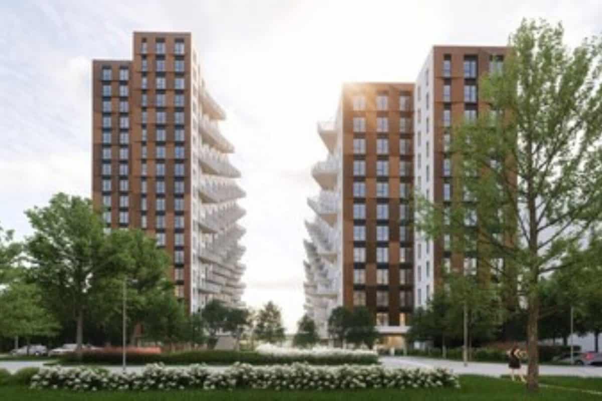 Simulation architecturale de trois tours résidentielles modernes entourées d'espaces verts et d'arbres matures